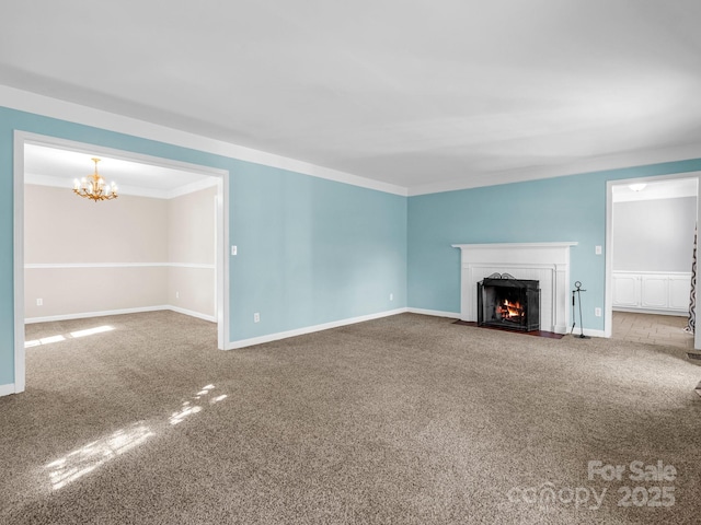 unfurnished living room with carpet floors, a fireplace with flush hearth, and baseboards