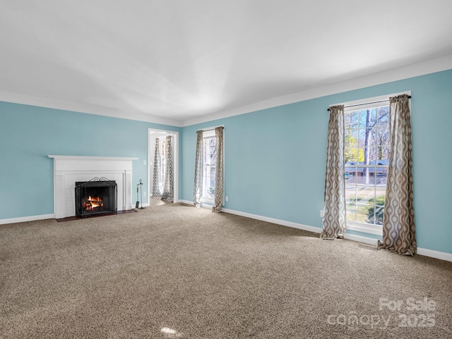 unfurnished living room featuring carpet floors, a brick fireplace, and baseboards