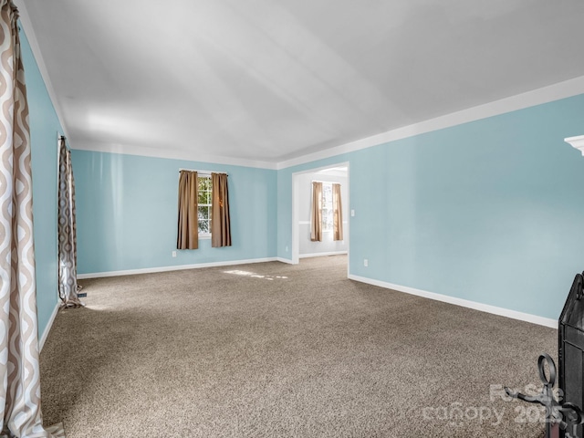 carpeted empty room featuring baseboards