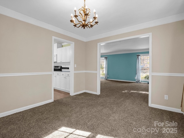 empty room featuring ornamental molding, dark carpet, and baseboards