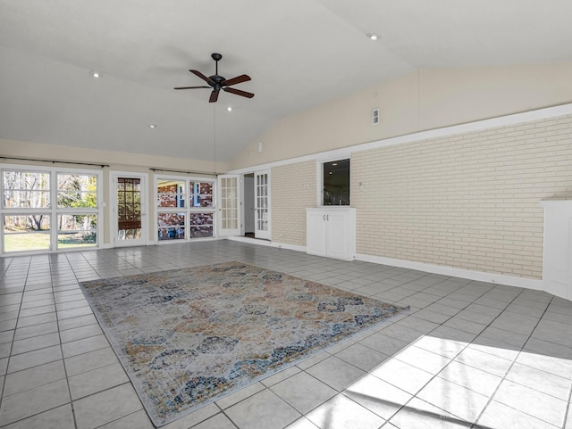 unfurnished living room featuring brick wall, high vaulted ceiling, ceiling fan, and tile patterned floors