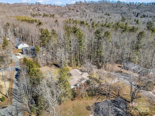 birds eye view of property with a forest view