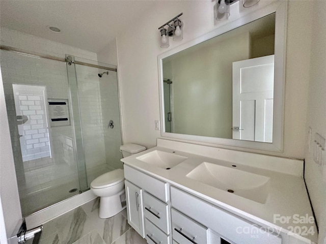 bathroom with vanity, toilet, and a shower with door