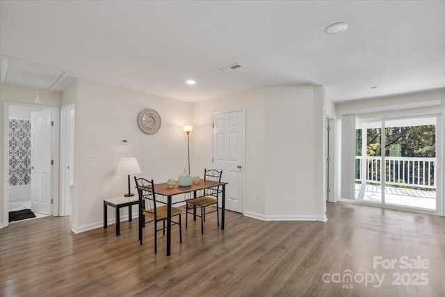 dining space with hardwood / wood-style flooring