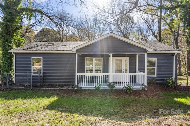 ranch-style house with covered porch and a front lawn