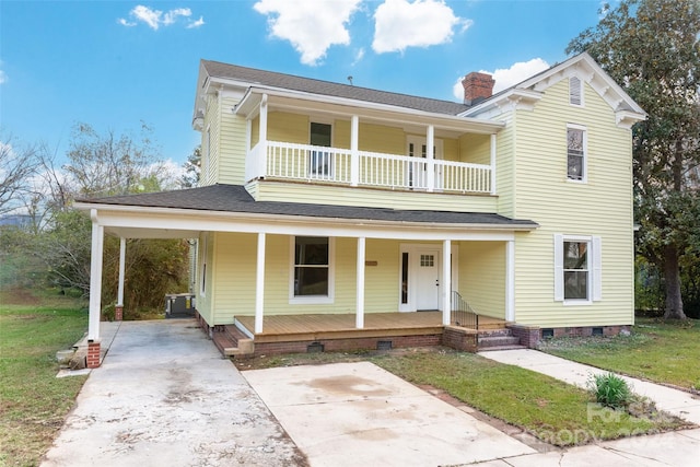 view of front facade with a balcony, covered porch, and a front yard