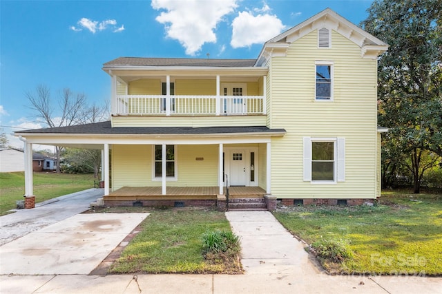 view of front of home featuring a front yard and a balcony