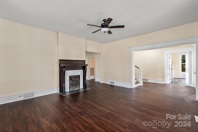 unfurnished living room with ceiling fan and dark wood-type flooring