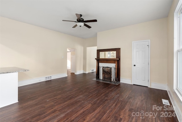 unfurnished living room with ceiling fan and dark hardwood / wood-style flooring