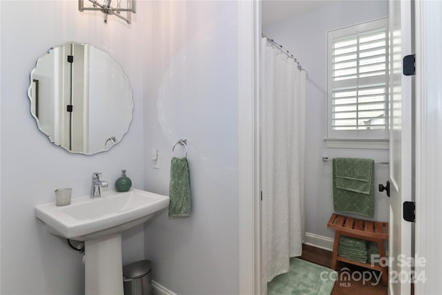 bathroom featuring hardwood / wood-style floors and a notable chandelier