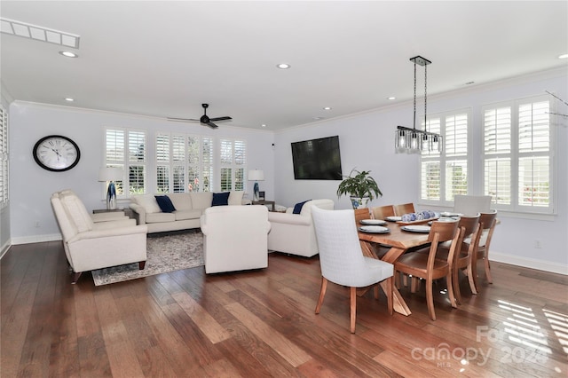 dining area featuring ceiling fan with notable chandelier, dark hardwood / wood-style flooring, crown molding, and a wealth of natural light