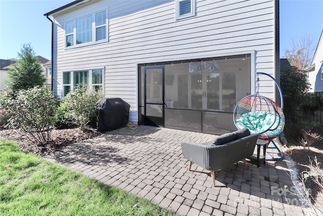 back of house with a sunroom and a patio area