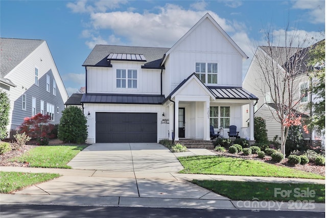 modern farmhouse style home featuring a garage and a front yard