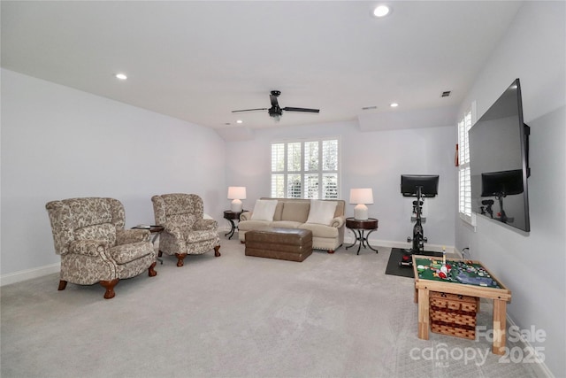 carpeted living room with ceiling fan