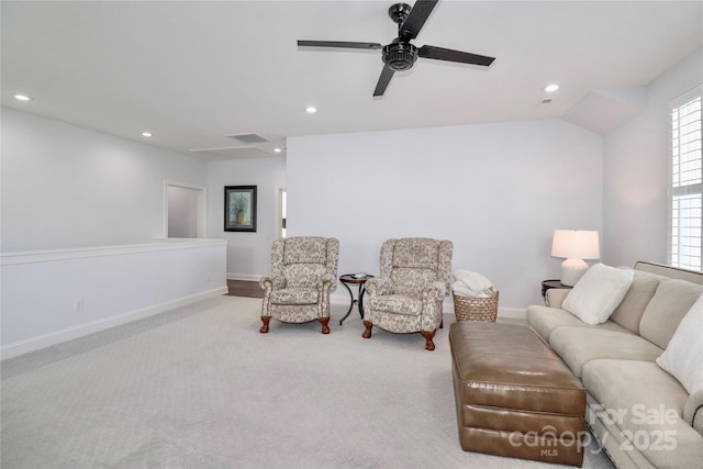 living area featuring light carpet and ceiling fan