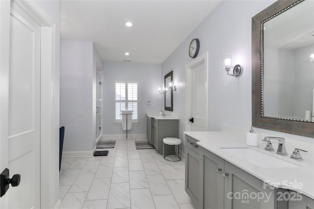 bathroom featuring walk in shower and vanity