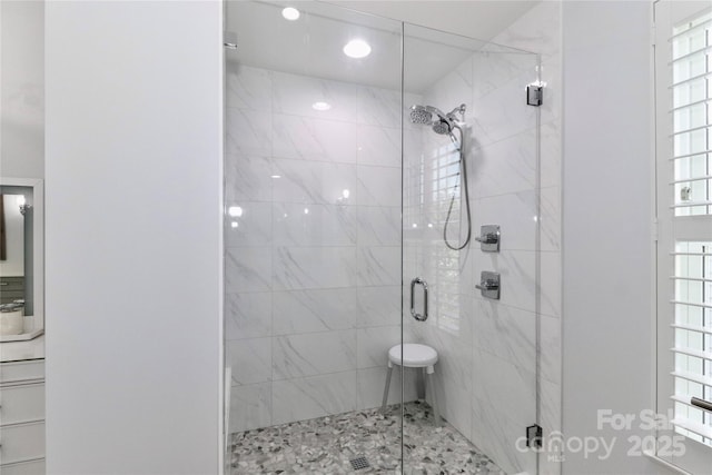 bathroom featuring plenty of natural light and walk in shower