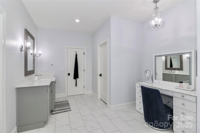 bathroom with vanity and an inviting chandelier