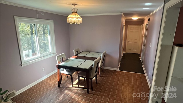 dining area featuring crown molding and a notable chandelier