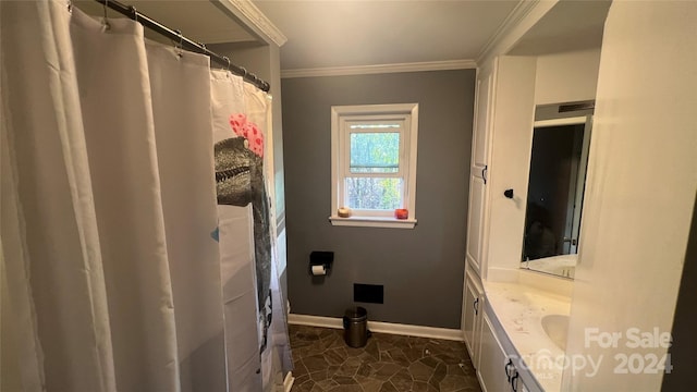 bathroom with vanity and ornamental molding