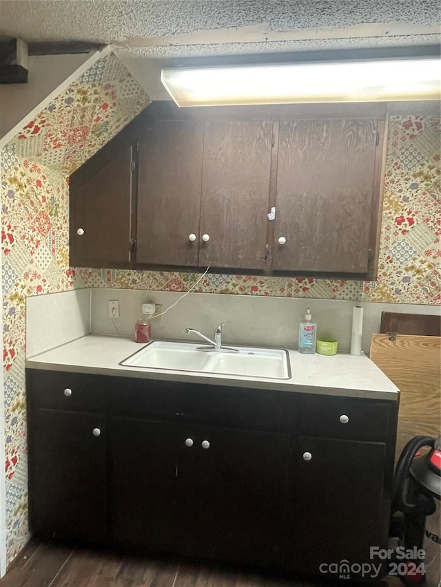 kitchen with sink and dark wood-type flooring