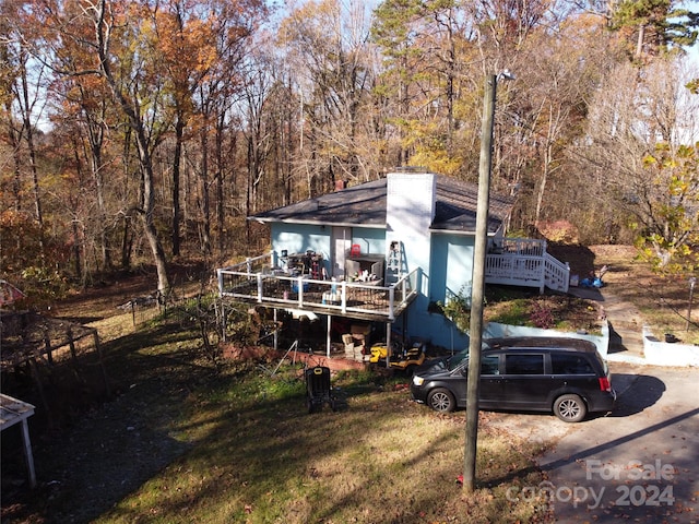 exterior space with a front yard and a deck