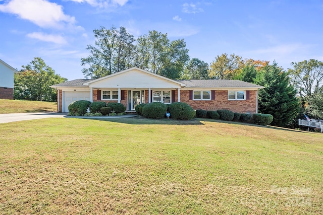 ranch-style house with a porch, a garage, and a front lawn