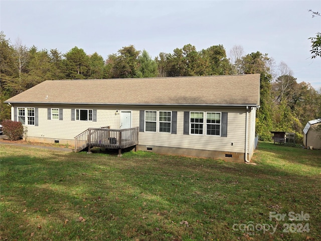 view of front of property with a front lawn and a wooden deck