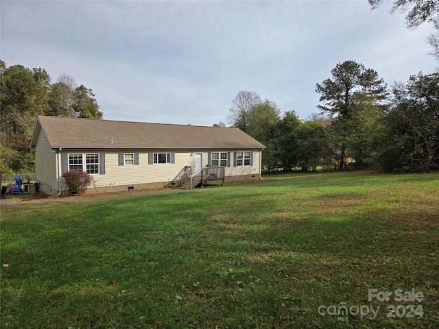 rear view of house with a lawn