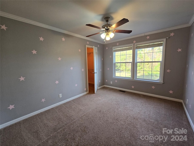 unfurnished bedroom featuring ceiling fan, carpet, and ornamental molding