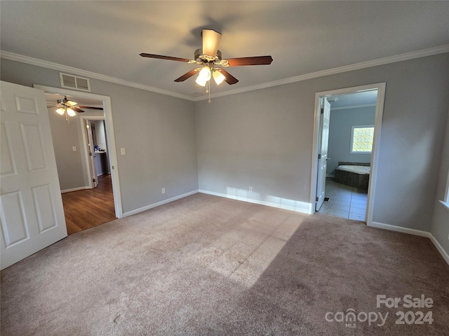 carpeted spare room featuring ceiling fan and ornamental molding