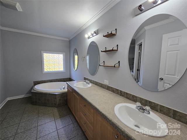 bathroom featuring tile patterned flooring, vanity, ornamental molding, and tiled bath