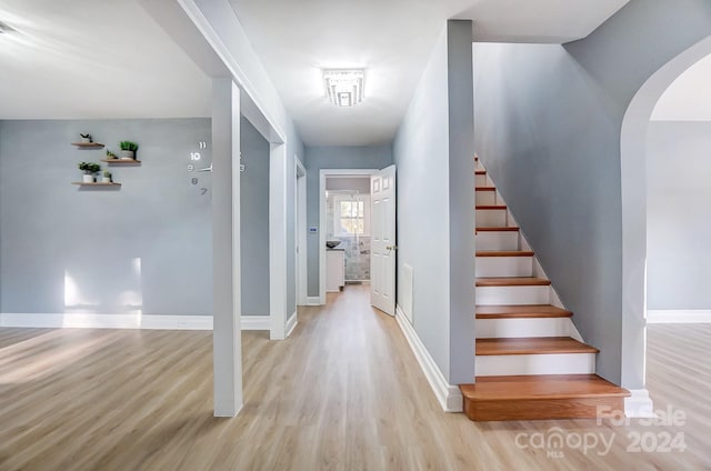 staircase with hardwood / wood-style floors