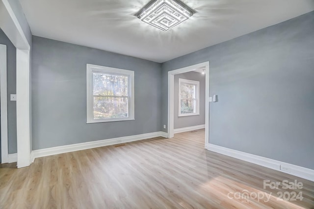 unfurnished room with light hardwood / wood-style floors