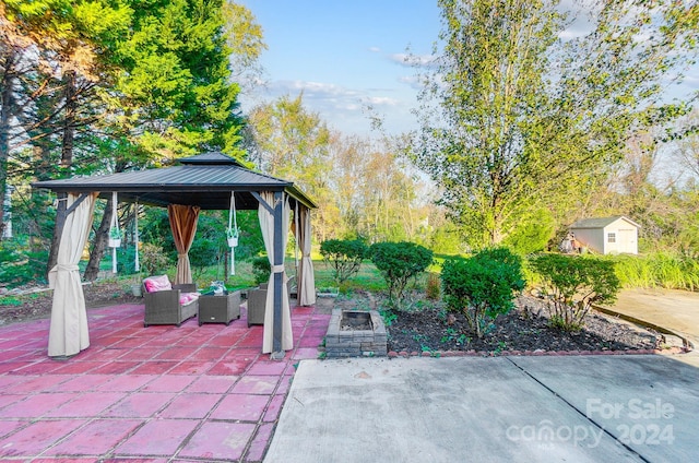 view of patio with outdoor lounge area, a gazebo, and a storage unit