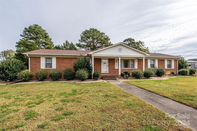 single story home with a porch and a front lawn