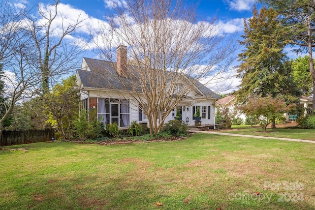 new england style home with a front lawn