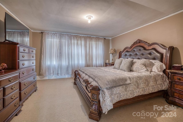 carpeted bedroom featuring crown molding