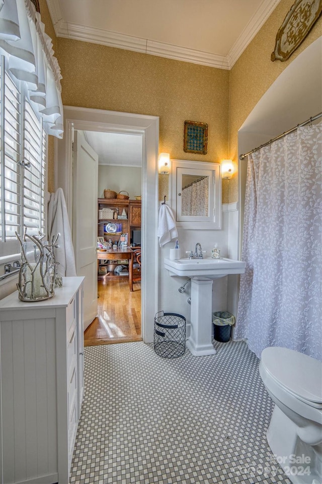 bathroom featuring wood-type flooring, toilet, and ornamental molding