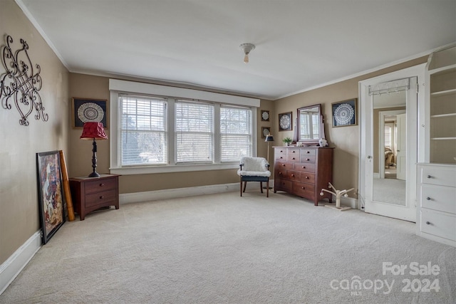 sitting room featuring light colored carpet and crown molding