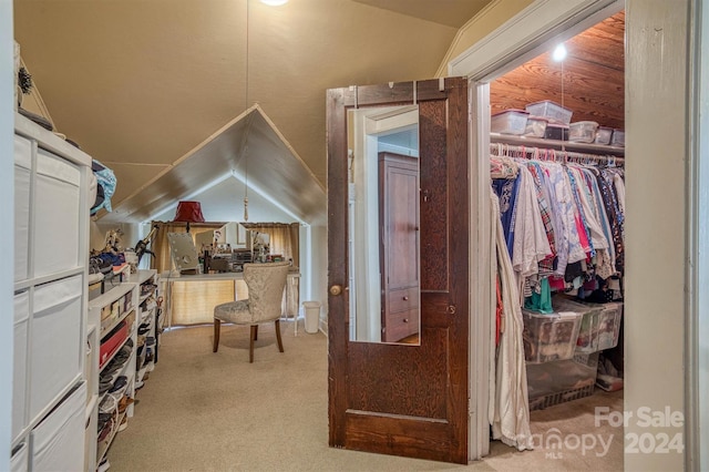 interior space featuring light carpet, a closet, and lofted ceiling