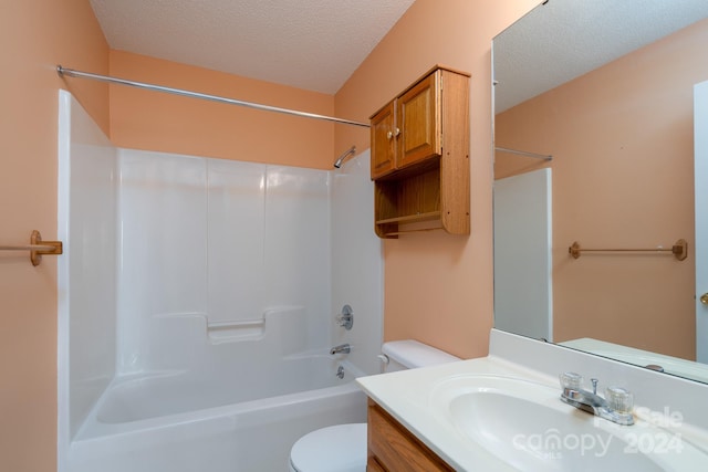 full bathroom with vanity, shower / tub combination, a textured ceiling, and toilet