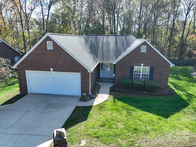 view of front of house featuring a garage and a front lawn