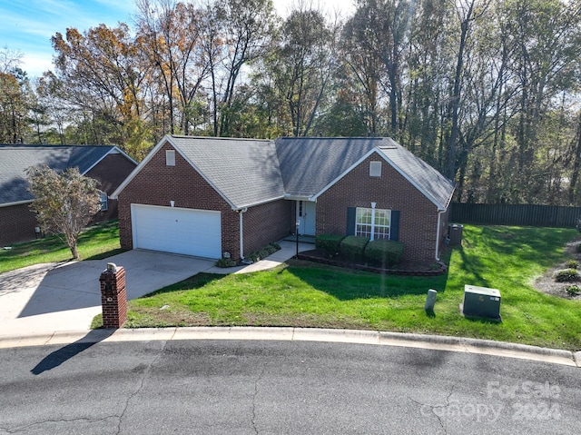 single story home with a front yard and a garage