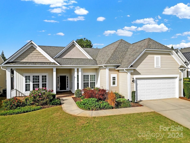 view of front of home with a garage and a front lawn