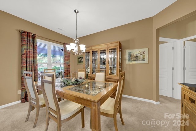 dining space with a chandelier and light colored carpet