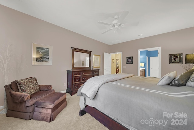 carpeted bedroom with connected bathroom and ceiling fan