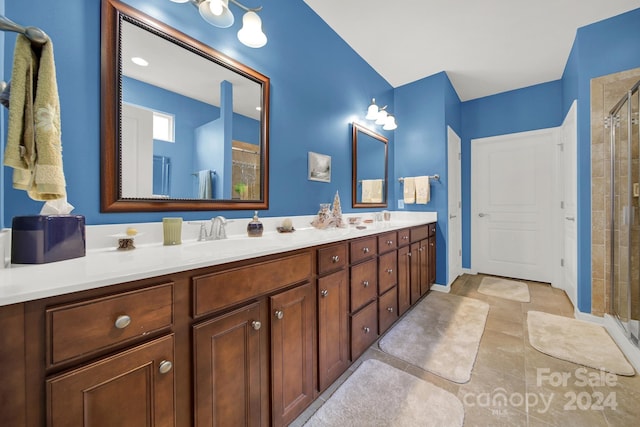 bathroom with vanity, tile patterned floors, and a shower with shower door