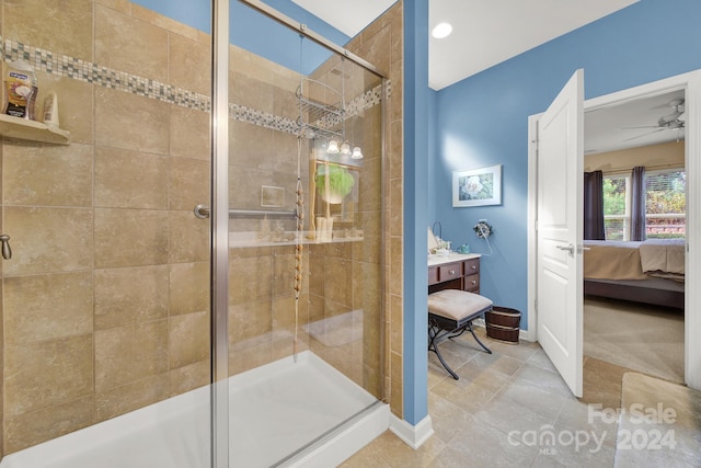 bathroom with ceiling fan, tile patterned flooring, and a shower with shower door