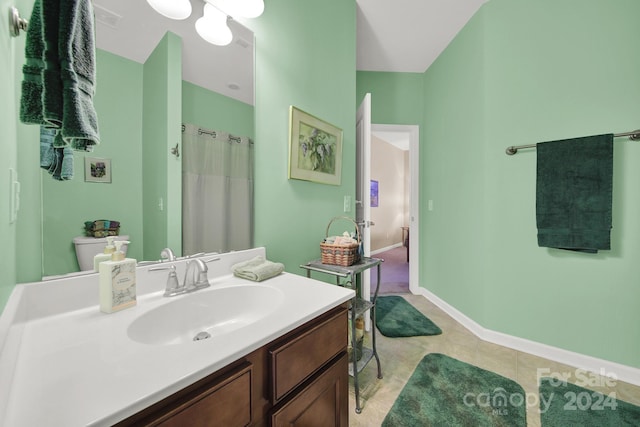 bathroom featuring tile patterned floors, vanity, and walk in shower